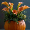 Celebrate the beauty of the season with our Autumn Grace Pumpkin Arrangement
