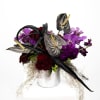 A hauntingly beautiful arrangement of vibrant Anthuriums, striking purple orchids, eerie succulents