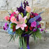 light pink roses and lilies, blue hydrangea and delphinium, purple stock, green