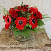 Anemone, and roses with berries in a vase. 