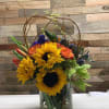Our Grateful Wishes is set in a cylinder with Sunflowers, poms, roses