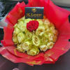 Soft creamy yellow roses, crowned by a solitary red rose which rises