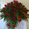 Red Roses with luscious greens to lay gently over the end of