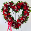This stunning funeral standing heart wreath features a vibrant arrangement of deep