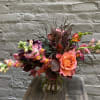 A vibrant autumnal arrangement of vivid Free Spirit roses and fiery snapdragons