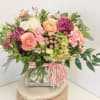 A lush mixed fresh flower arrangement with pastels and a romantic feel&mdash;florals