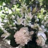 A beautiful and elegant collection of all white blossoms featuring lilies and