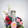 This peaceful arrangement features a graceful angel surrounded by a mix of