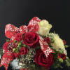 This adorable peppermint container filled with red and white blooms. A perfect