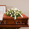 An all white casket spray is simply elegant.