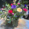 Designed using blue anemones, peachy Juliet garden roses, pink snapdragons, hot pink