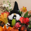 a spooky arrangement filled with a witch gnome 