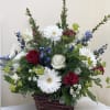 A great arrangement for him, we use seasonal flowers but keep to