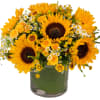 Sunflowers, spray roses and more designed in a leaf wrapped glass vase.
As
