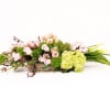 

long wooden centerpiece featuring rusty pink roses, branches, hydrangea, tulips, calla lilies