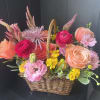 Seasonal, colorful flowers and foliage artfully arranged in a rectangular woven basket.

Year