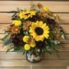 This beautiful arrangement includes sunflowers and other fall flowers in a fun