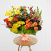 A beautiful Chinoiserie vase filled with green hydrangea, orange spray roses, snapdragon