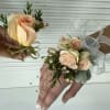 Peach spray roses, white ribbons and gold accents. 
