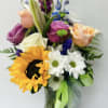 A mix of colorful roses, sunflowers, poms, and greenery, perfect for any