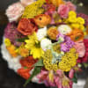 Bright flowers arranged in a lower vase. Perfect for an office or