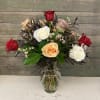 This classic arrangement features 12 mixed colored roses with premium greens and