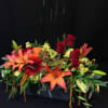 Rustic box of fall flowers and roses. Colors and items will vary.
