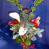 Delightful small bud vase of cheerful Christmasy accents and items.  Vase
