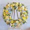 A beautiful, radiant tribute crafted with soft pastels and cheerful yellow blooms