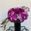 vibrant arrangement designed with bold magenta tones and soft lavender accents.
