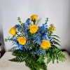 Yellow roses engulfed in blue stock, blue baby&#039;s breath a assorted greens