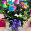 A mesmerizing bouquet of vibrant rainbow roses, each petal bursting with a