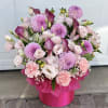 This exquisite arrangement in soft pink and lilac shades is made for