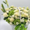 An elegant floral basket in white and green tones &mdash; the embodiment