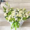 An elegant floral basket in white and green tones &mdash; the embodiment