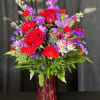 Experience regal elegance with this majestic arrangement of red roses, red carnations