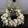 White snapdragons, carnations, spray roses, oriental lilies, alstroemeria, white cushion mums, 