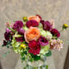 This arrangement includes Seasonal Pink Dahlias, Beautiful Magenta Lisianthus, Green Hydrangeas, Pale