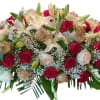This casket spray is made with red and gold roses and lilies.