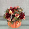 This festive pumpkin vase overflows with autumn charm, featuring deep burgundy mums