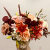Nestled within a clear glass vase, this composition is a harmonious symphony