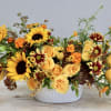 This arrangement pairs together sunflowers with roses for the perfect fall themed
