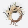 This hand-made, asymmetrical wreath includes an assortment of dried florals in shades