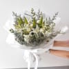 A serene and elegant bouquet crafted with pristine white lilies, delicate stock