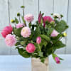A beautiful whimsical design of peonies, dahlias and tulips. Nestled in a