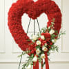 A timeless expression of devotion.
This striking heart-shaped funeral wreath features rich crimson