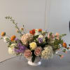 A warm embrace of autumn elegance.
This luxurious arrangement blends toffee, burnt orange