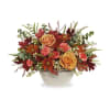 A timeless Thanksgiving flower centerpiece featuring autumn roses, carnations, and leaves in
