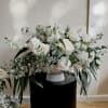Lovely soft whites and eucalyptus. A classy, simple and elegant table arrangement.