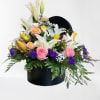 This beautiful arrangement holds a variety of bright flowers that will make